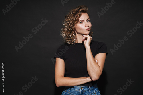 Thoughtful cute young woman looking aside.