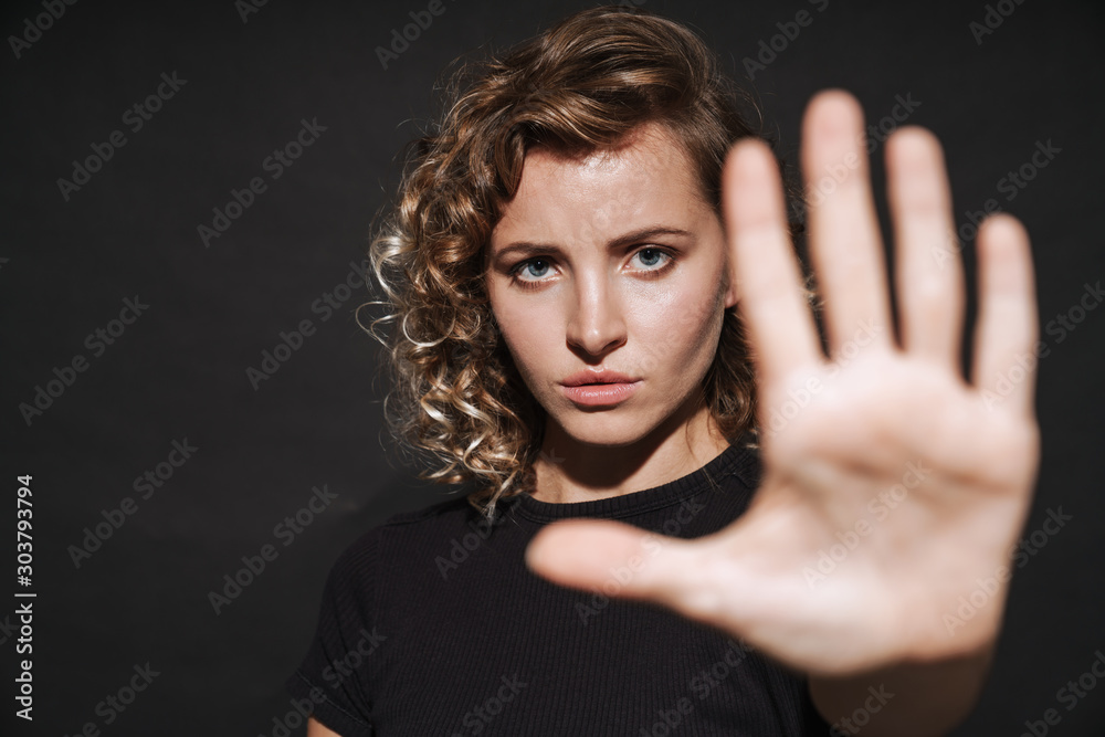 Serious cute young woman make stop gesture. Serious cute young woman make stop gesture.