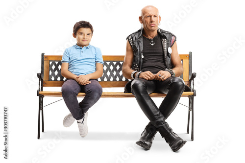 Punk man sitting on a bench with a little boy