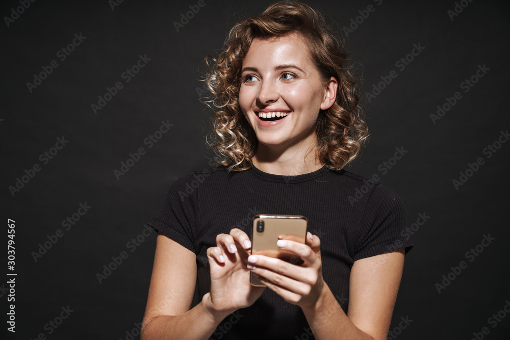 Smiling young woman using mobile phone. Smiling young woman using mobile phone.