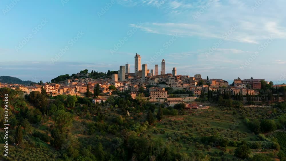 Wide view of the town of San Gimignano, Tuscany Italy with its famous medieval towers. Panning aerial from a drone. Wide view of the town of San Gimignano, Tuscany Italy with its famous medieval towers. Panning aerial from a drone.