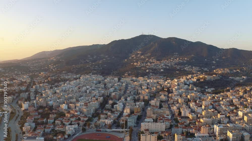Sunrise Aerial drone Flight over mountains to downtown mitilini revealing sea with ferry to athens, lesvos, greece Sunrise Aerial drone Flight over mountains to downtown mitilini revealing sea with ferry to athens, lesvos, greece