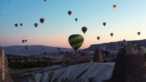 Early morning silhouetted hot air balloons against the skies of Goreme Cappadocia, Turkey photo