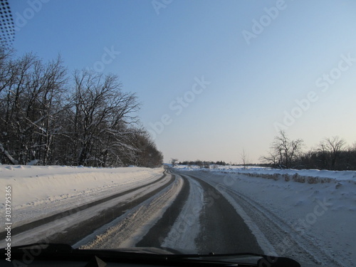 view of the snow-covered track from the windshield of the car