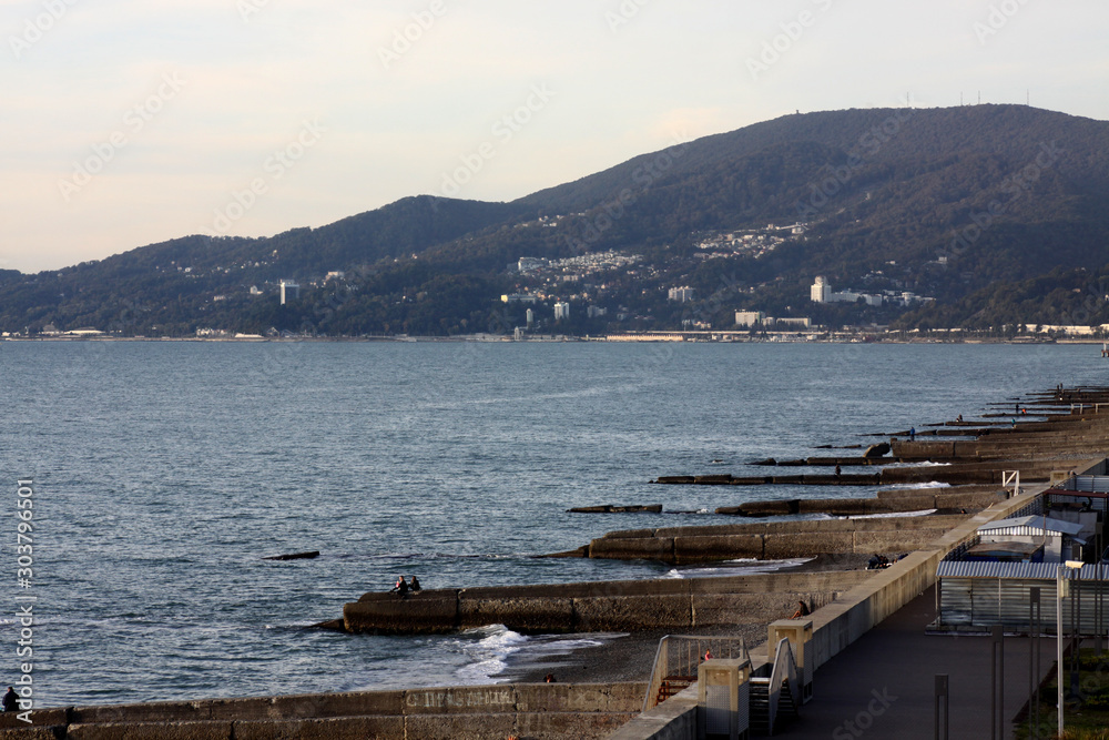view over the sea and breakwaters with a mountain on the background