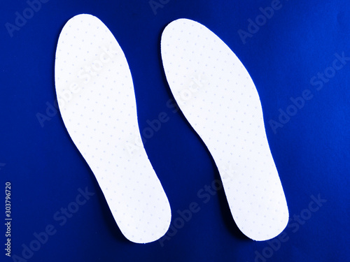 Inseat insole in white shoes On a blue background