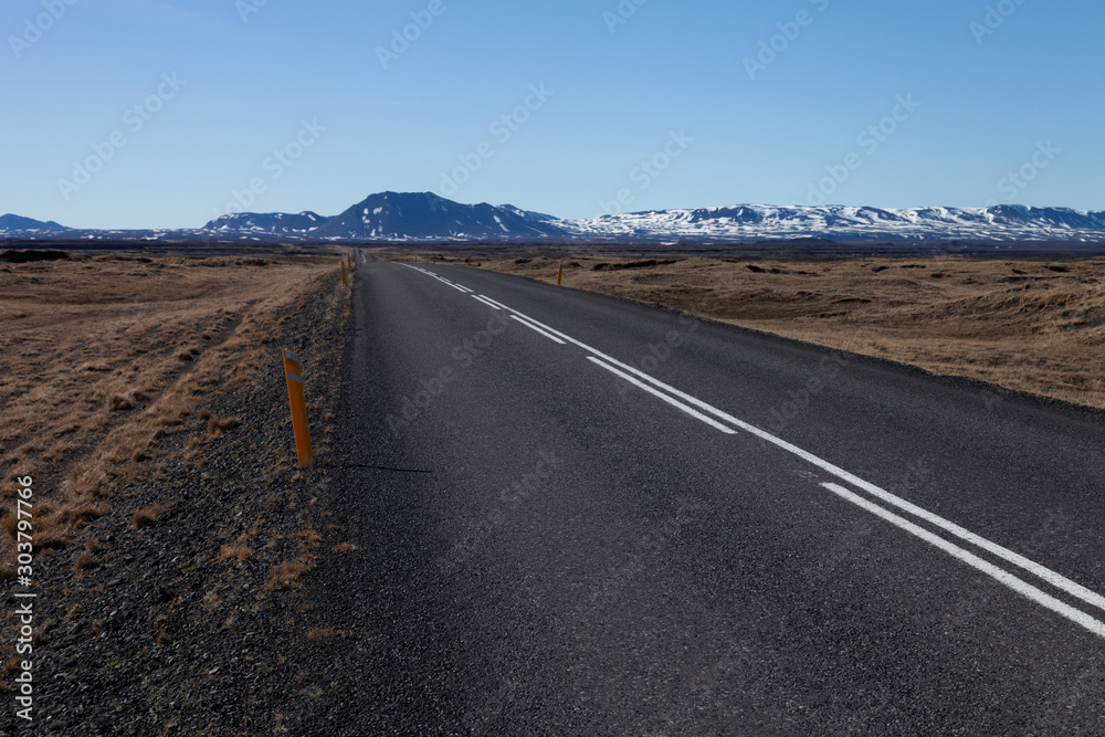 Road on a calm deserted spring landscape of Iceland.