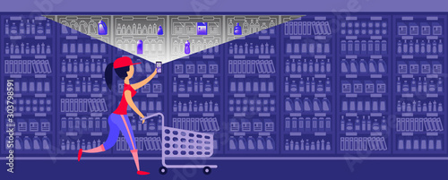 Young woman are pushing shopping cart and making a choice of some necessary goods in a supermarket used new technology. Scanning QR codes.