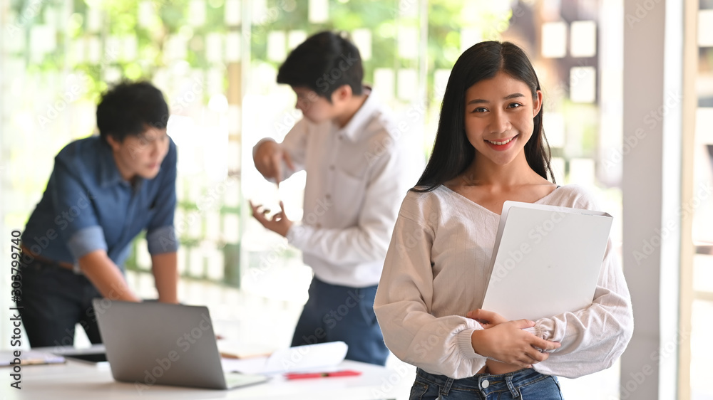 Confidently asian architect female standing on front of meeting architecture table. Confidently asian architect female standing on front of meeting architecture table.