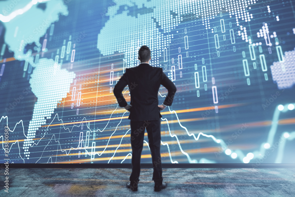 Businessman and forex graph and world map hologram. Double exposure. Concept of financial education and analysis Businessman and forex graph and world map hologram. Double exposure. Concept of financial education and analysis