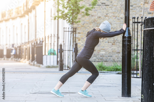 Woman running in the morning in streets of London photo