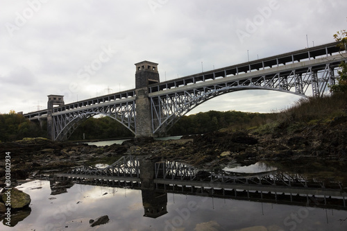 Reflection of the Grade II Listed Britannia Bridge on the surface of the Menai Strait nearer to shore, Isle of Anglesey, North Wales photo