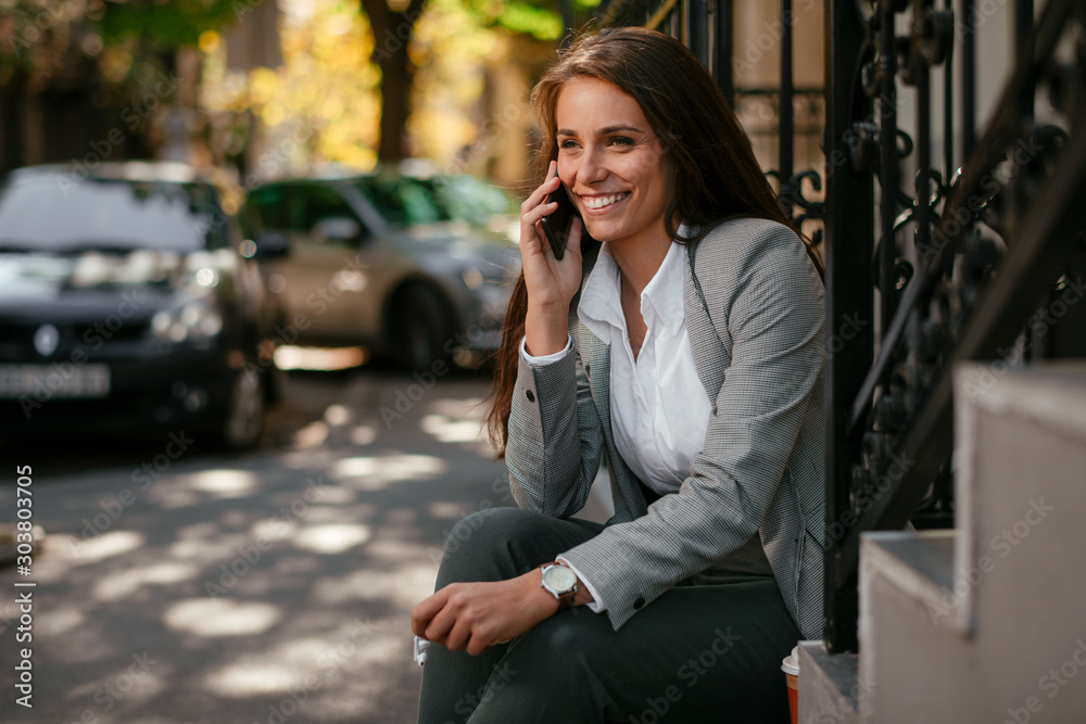 Young businesswoman outside. Beautiful woman having a business call. 