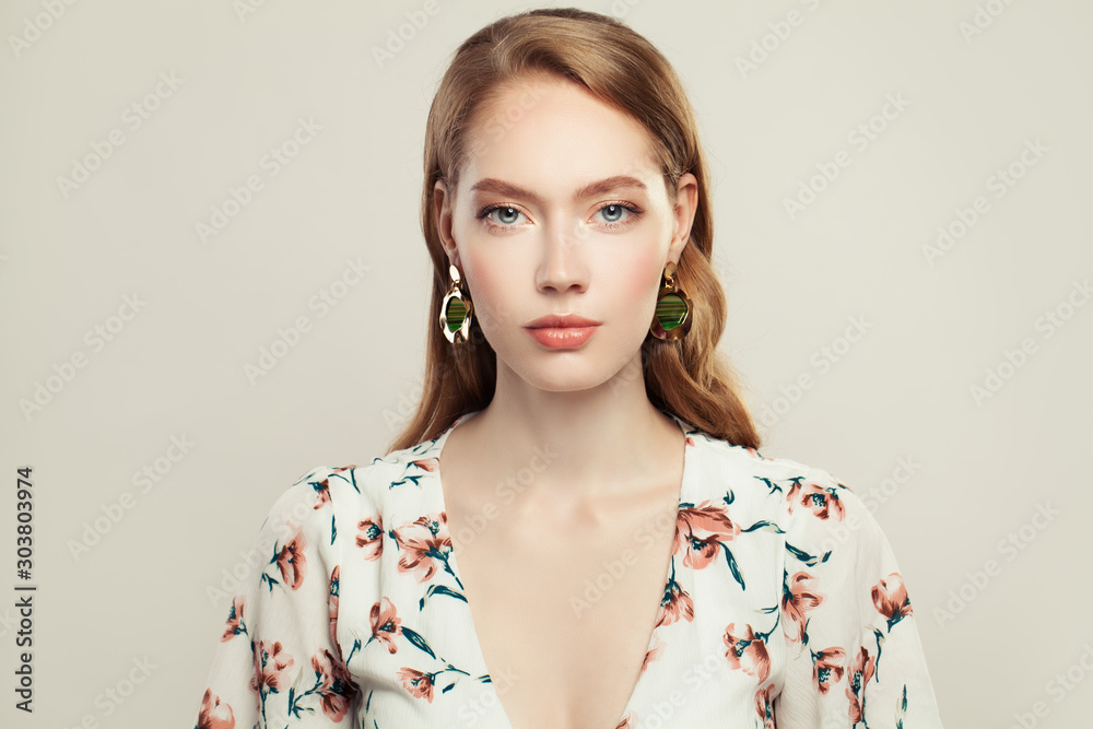 Pretty elegant woman fashion model wearing golden chain earrings on white background Pretty elegant woman fashion model wearing golden chain earrings on white background