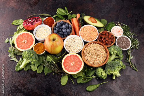 Fototapeta Naklejka Na Ścianę i Meble -  Healthy food clean eating selection: fruit, vegetable, seeds, superfood, cereals, leaf vegetable on rustic background