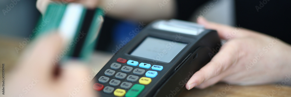 Cashier Hand Taking Plastic Credit Card to Payment Cashier Hand Taking Plastic Credit Card to Payment
