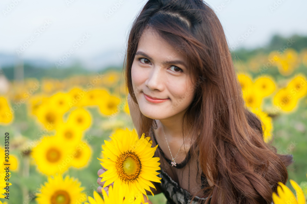 Young woman with a bouquet of sunflowers in the field Young woman with a bouquet of sunflowers in the field