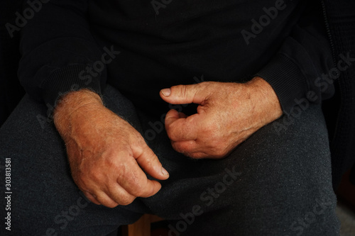 man with hands on black background