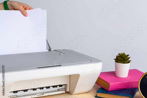 Close up of woman using a printer machine