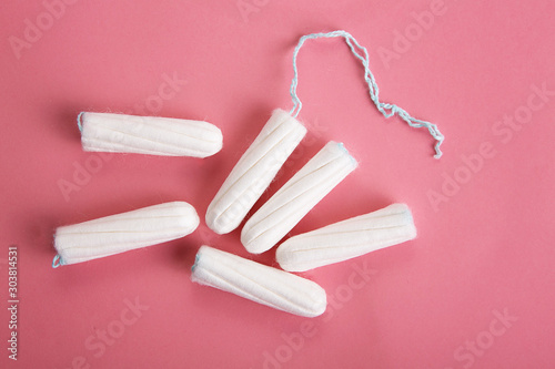 Medical female tampon on a pink background.