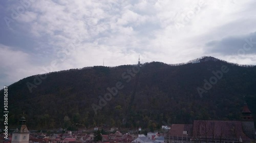 A view of mountain Tampa and a part of the old city of Brasov, Romania. Shot during autumn. You can see the Brasov sign on the mountain and also the route of the cablecar. photo