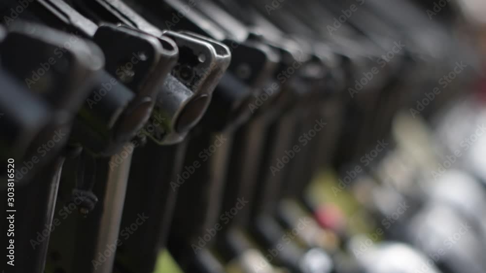 Selective focus pulling on many paintball pneumatic guns on a stand Selective focus pulling on many paintball pneumatic guns on a stand