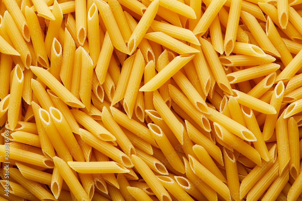 top view of raw penne seamless background pattern top view of raw penne seamless background pattern