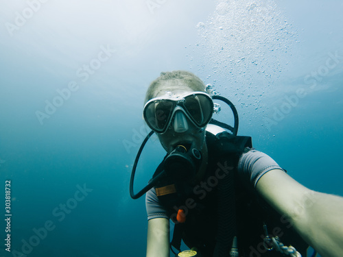 Sportive female taking selfie underwater