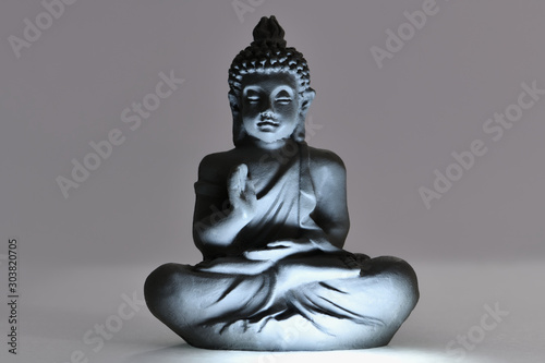 Buddha figure in beautiful light. Peaceful relaxation and meditation. Zen Buddhism.