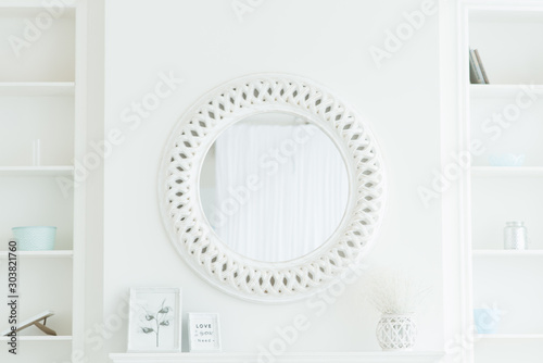 Round white mirror on a light background