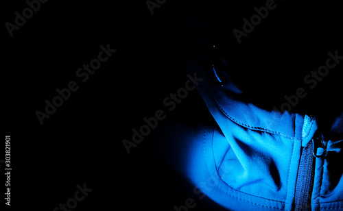 Detailed view of softshell jacket with water drops, zipper and seams. blue background photo
