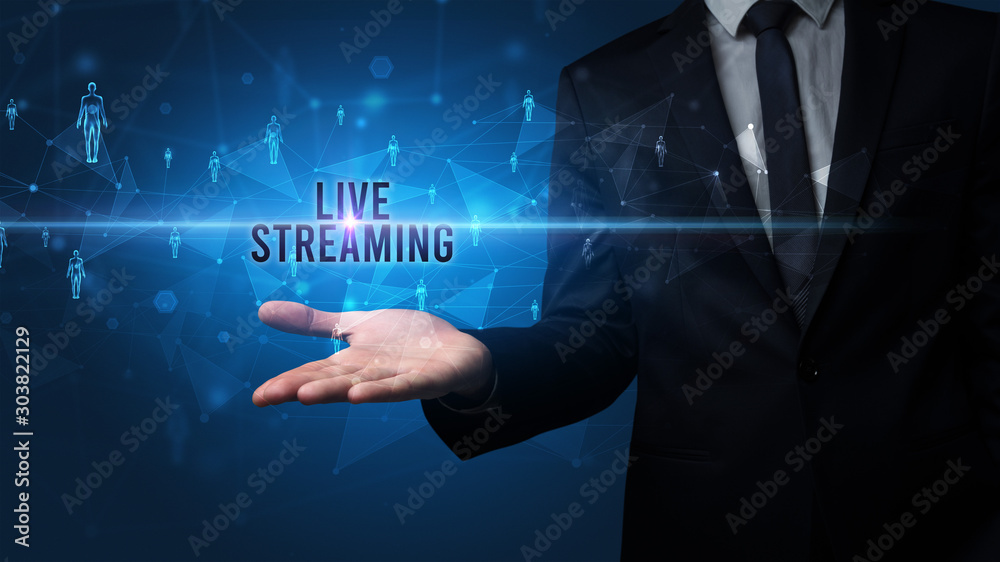 Elegant hand holding LIVE STREAMING inscription, social networking concept Elegant hand holding LIVE STREAMING inscription, social networking concept