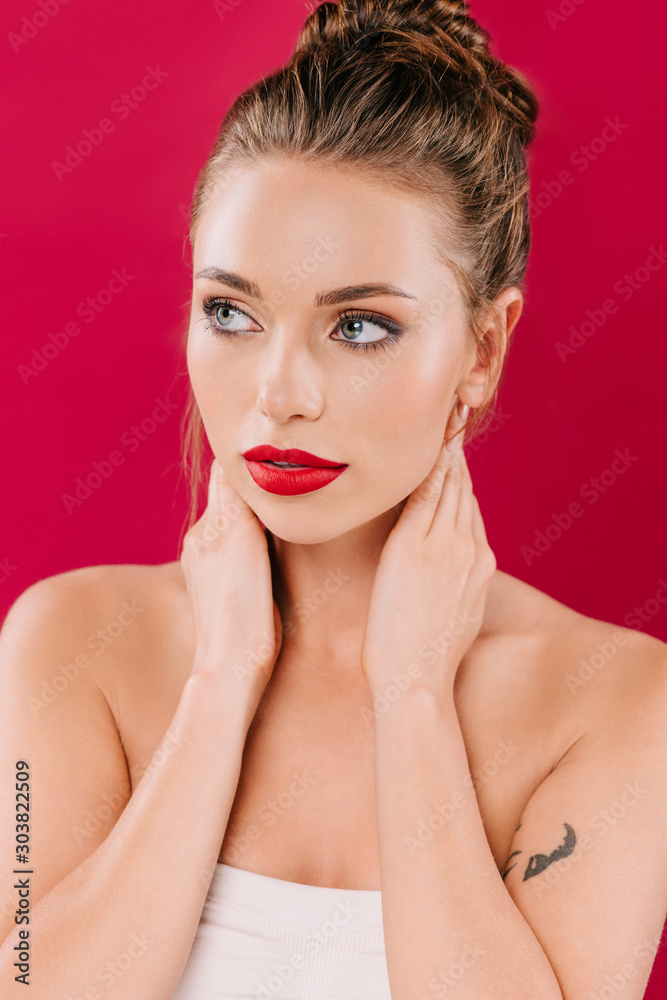 beautiful woman with red lips posing with hands on neck isolated on red beautiful woman with red lips posing with hands on neck isolated on red
