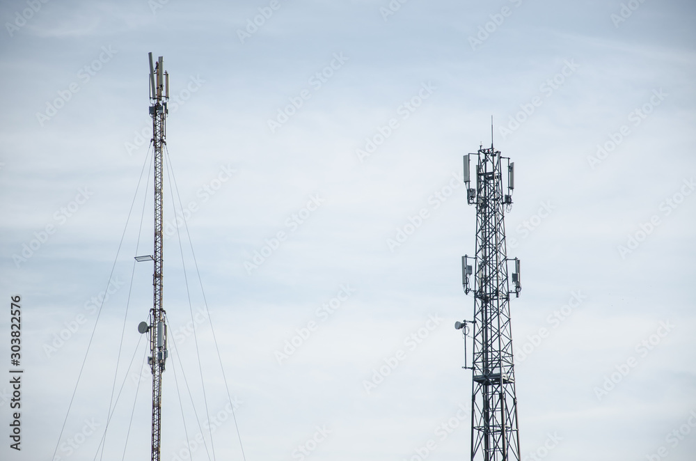 3G, 4G. Mobile phone base station. Development of communication system in urban area with blue sky background. 3G, 4G. Mobile phone base station. Development of communication system in urban area with blue sky background.