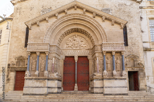 Ornate door of a carved stone church with columns in Arles in Provence, France © rachel