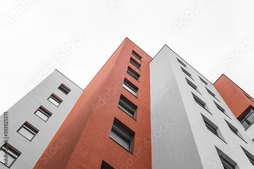 Office building, architecture background concept. red and white colour, geometric and white sky