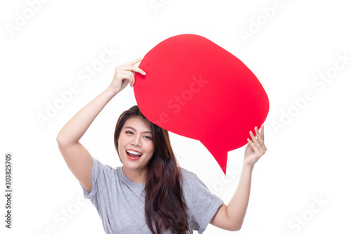 Attractive beautiful young asian woman smile and excited holding empty speech bubble isolated on white background.