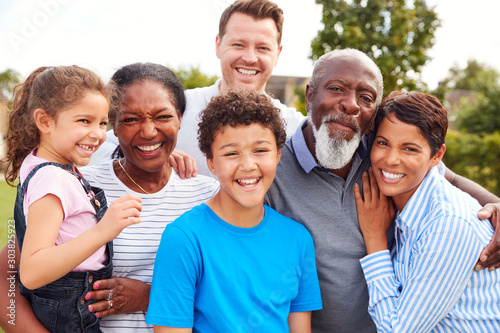 Portrait Of Smiling Multi-Generation Mixed Race Family In Garden At Home