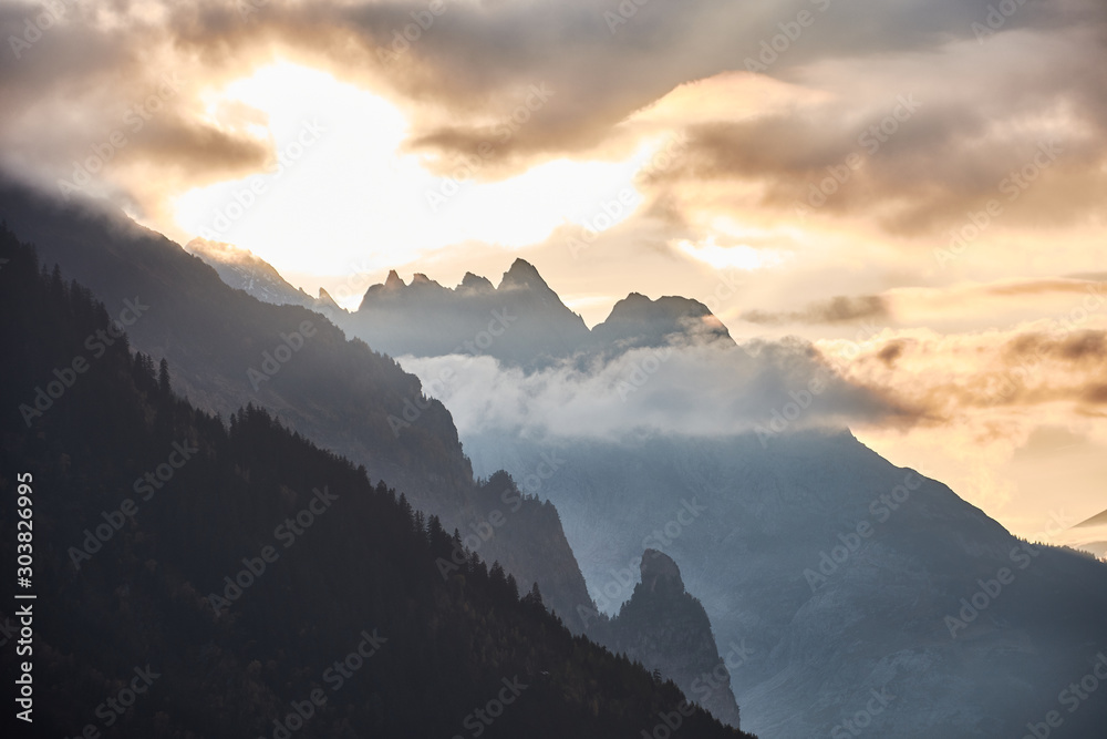 The last rays of the sun on the Mittelhorn, Wetterhorn and Rosenhorn peaks, seen from the path to the Trift suspension bridge (Triftbrücke). Switzerland The last rays of the sun on the Mittelhorn, Wetterhorn and Rosenhorn peaks, seen from the path to the Trift suspension bridge (Triftbrücke). Switzerland