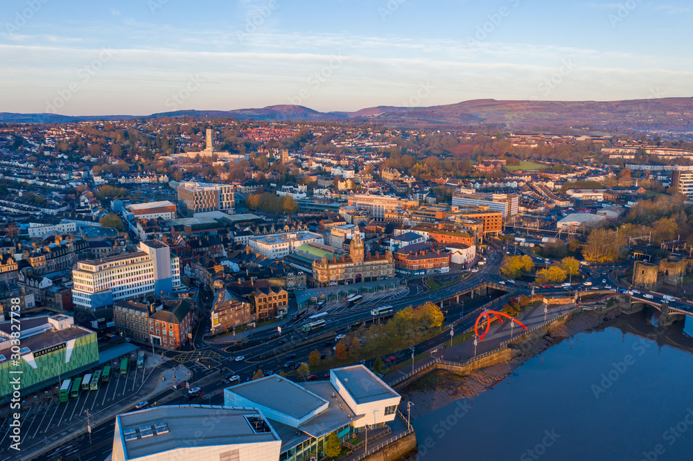 Obraz premium An aerial view at sunrise of Newport city centre, south wales United Kingdom, taken from the River Usk
