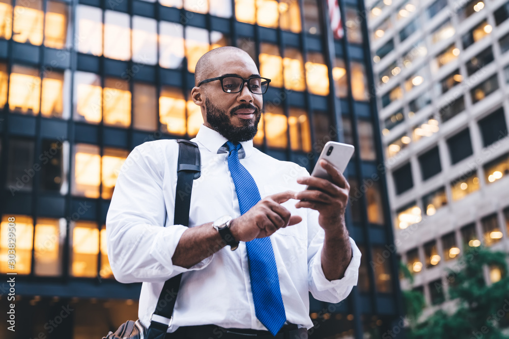 © BullRun - Ethnic bearded executive using smartphone