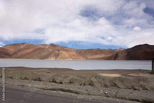 View landscape with Himalayas mountains and Pangong Tso high grassland lake while winter season for indian and tibetan and foreigner travelers travel visit at Leh Ladakh in Jammu and Kashmir, India