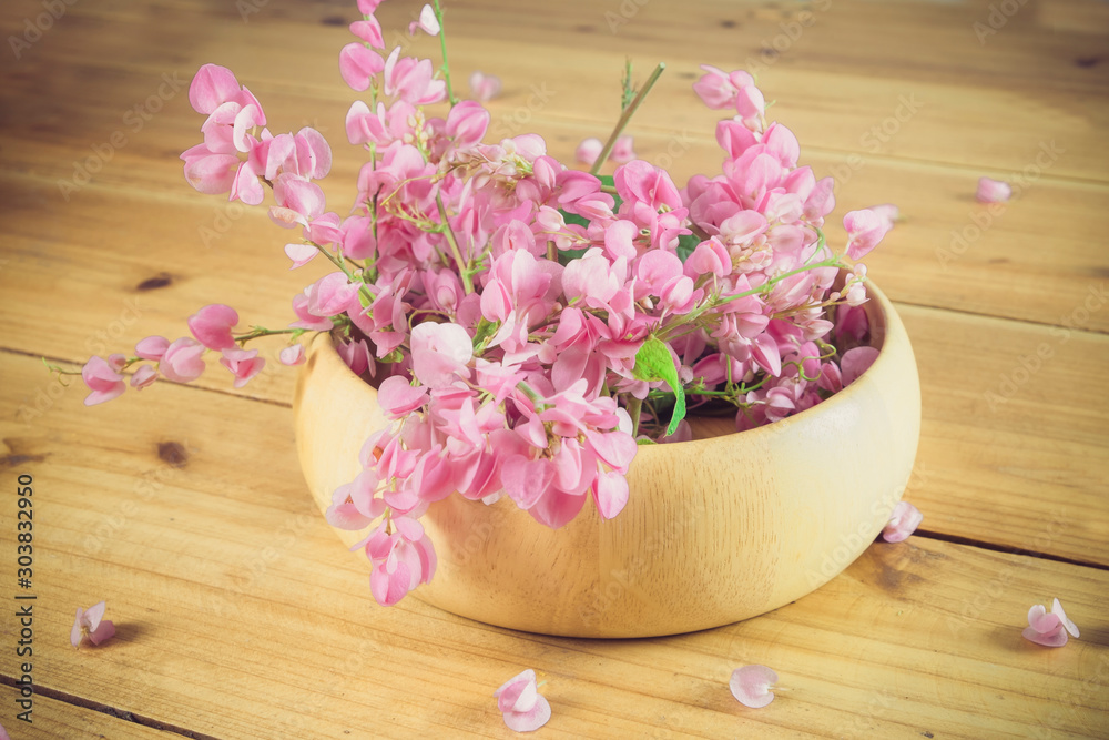Still life with pink flowers on wooden table over grunge background Still life with pink flowers on wooden table over grunge background