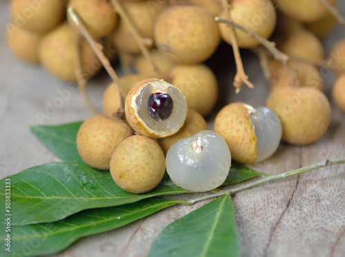 Fresh longan isolated on wooden background photo