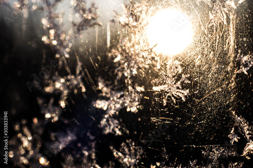 Winter patterns on the window, frozen water, snowflakes, macro photo. photo