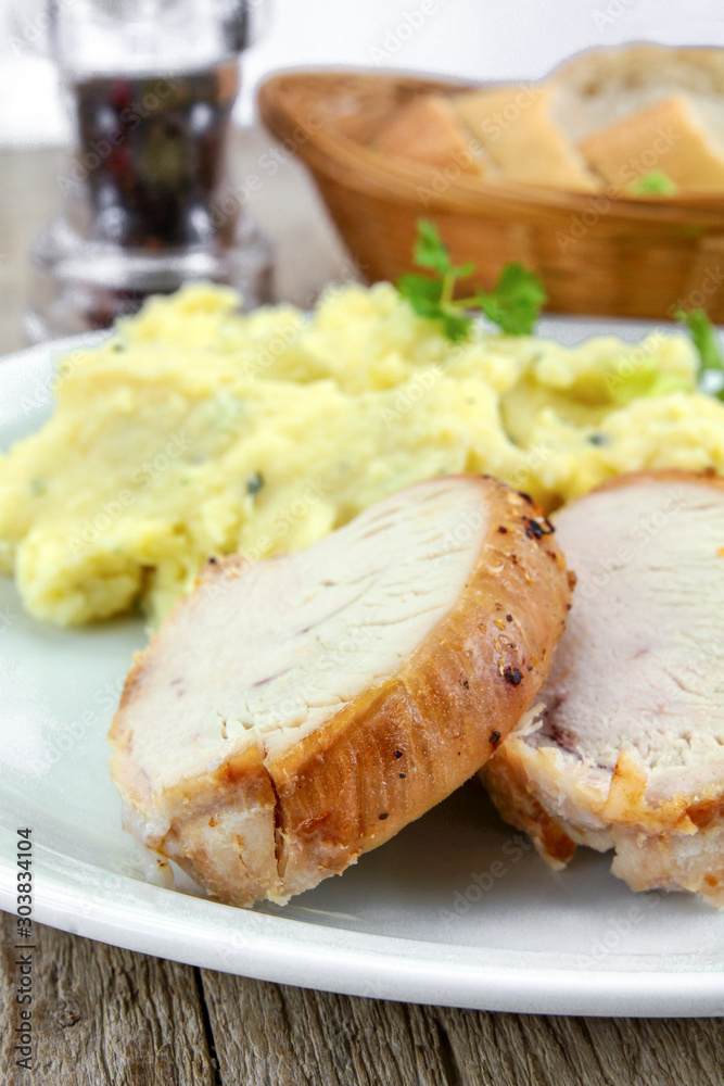 plate of roast pork and mashed potatoes