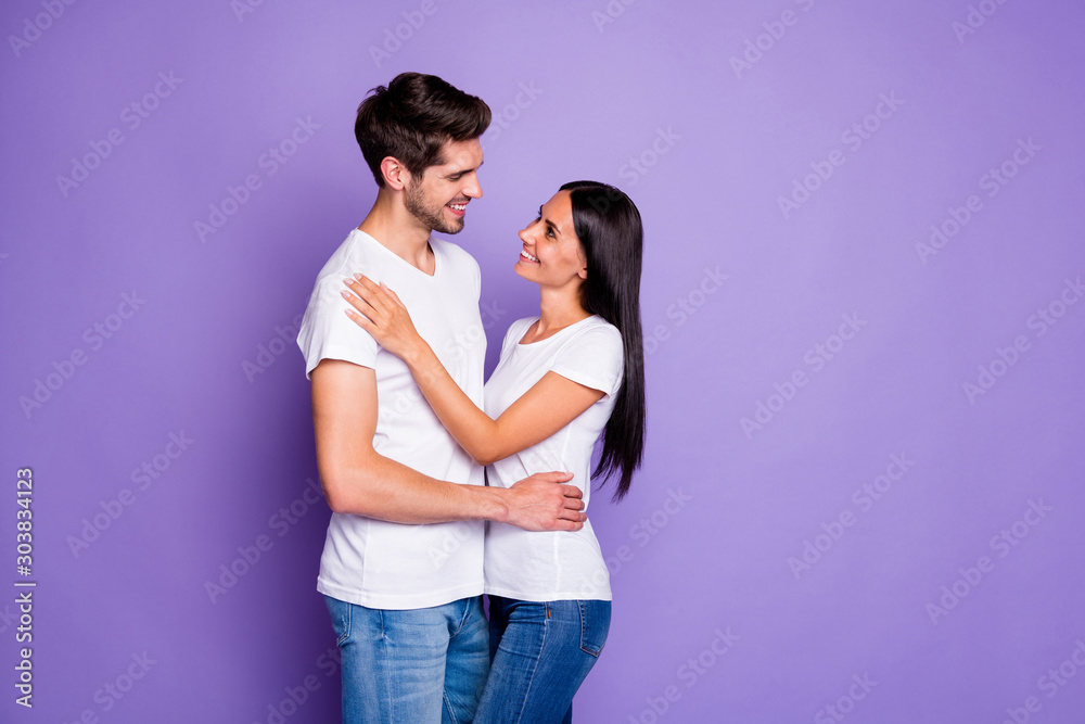 Profile side view portrait of his he her she nice attractive affectionate cheerful sweet couple soulmate embracing spending vacation isolated on purple violet lilac color pastel background Profile side view portrait of his he her she nice attractive affectionate cheerful sweet couple soulmate embracing spending vacation isolated on purple violet lilac color pastel background