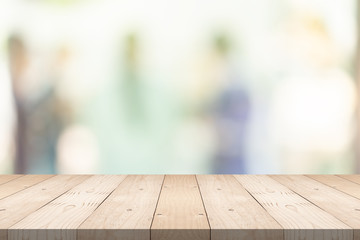 Empty brown wood table top on blur background at shopping mall, copy space for montage you product