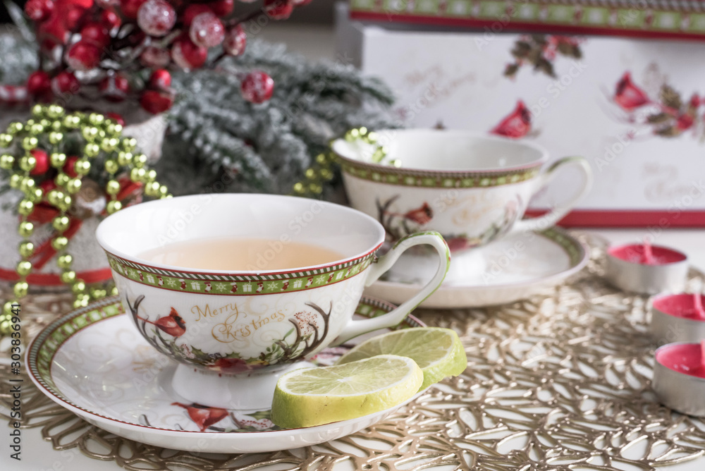 Christmas composition with flowers and white tea cups Christmas composition with flowers and white tea cups