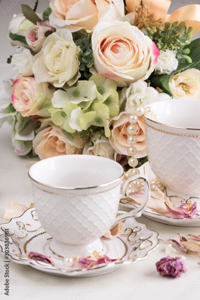 Christmas composition with flowers and white tea cups Christmas composition with flowers and white tea cups